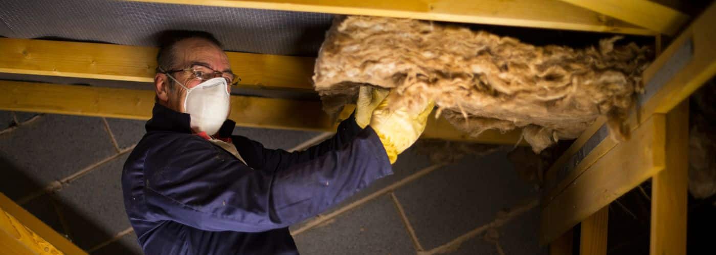 contractor inspecting insulation in a seattle home attic