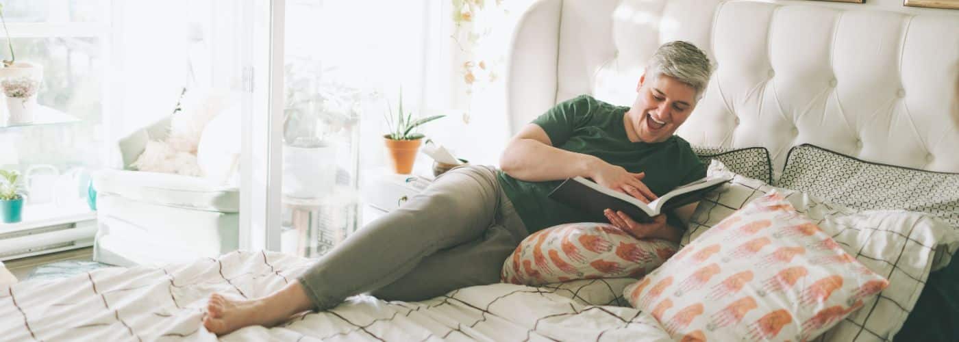 woman relaxing in her seattle home reading a book